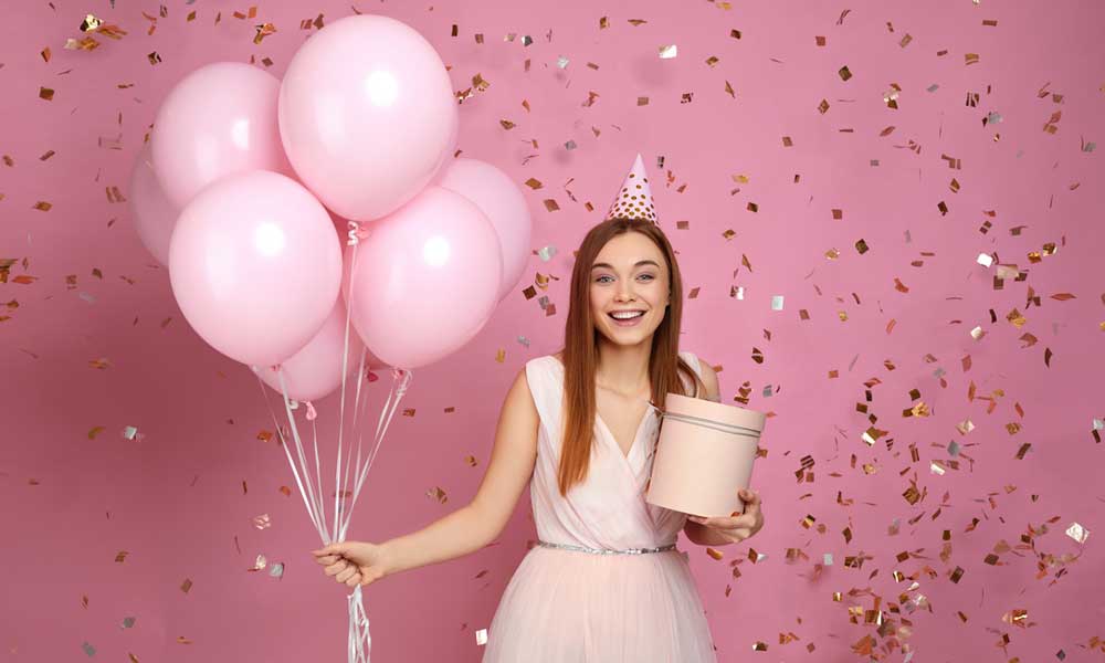 Throwing Paper Confetti Into The Air With A Bouquet Of Balloons